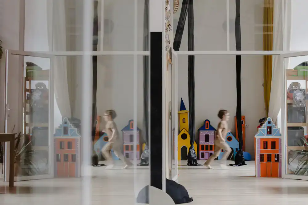 Children building a giant wooden marble run