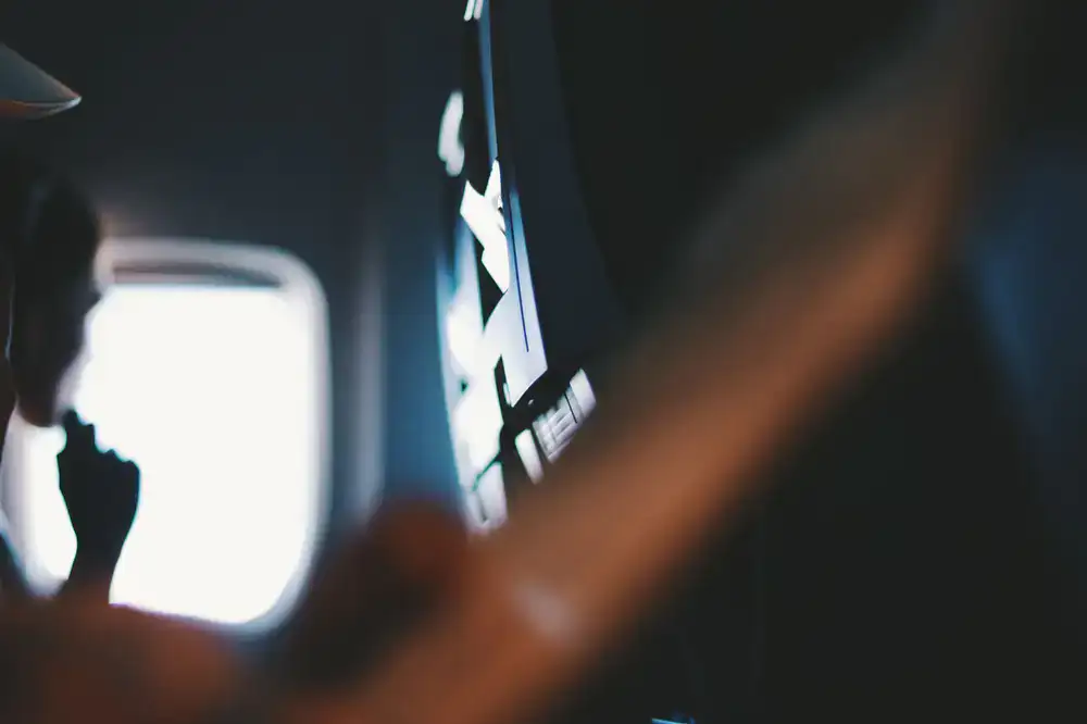 Kids inside a dark mock-up spaceship cabin looking at glowing screens