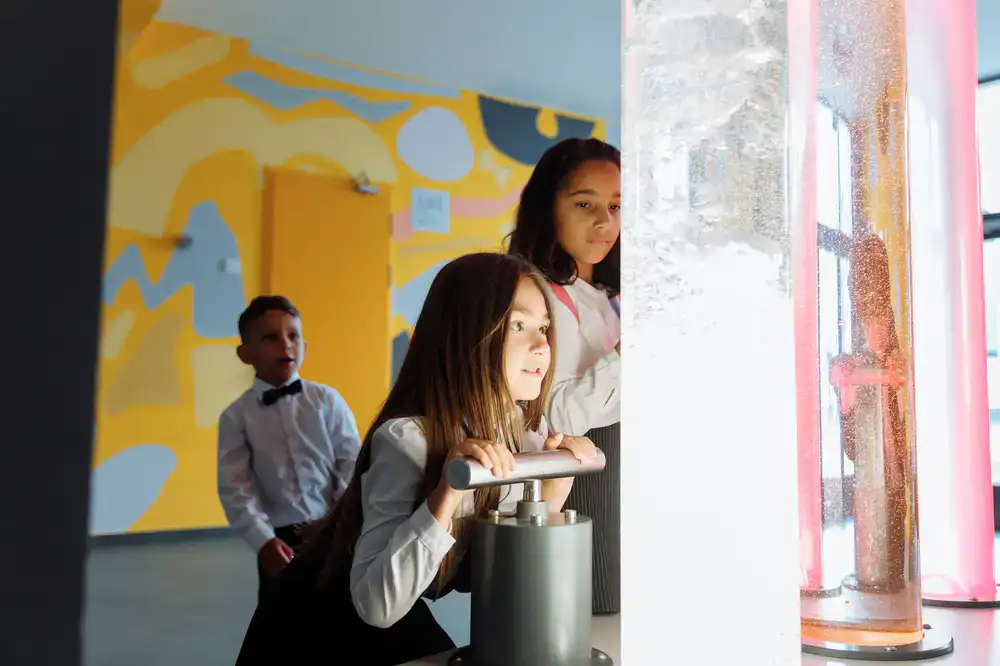 A group of excited school children observing a science experiment