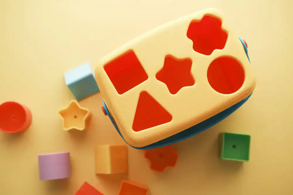 Toddlers playing with colorful sensory blocks