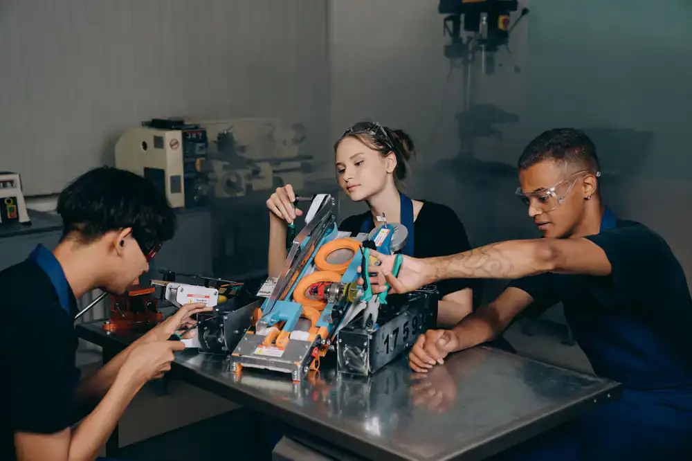 Older students working on a small robotic vehicle