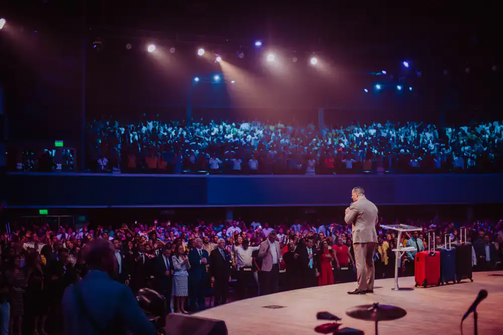 Presenter demonstrating a safe foam reaction on stage to an excited audience